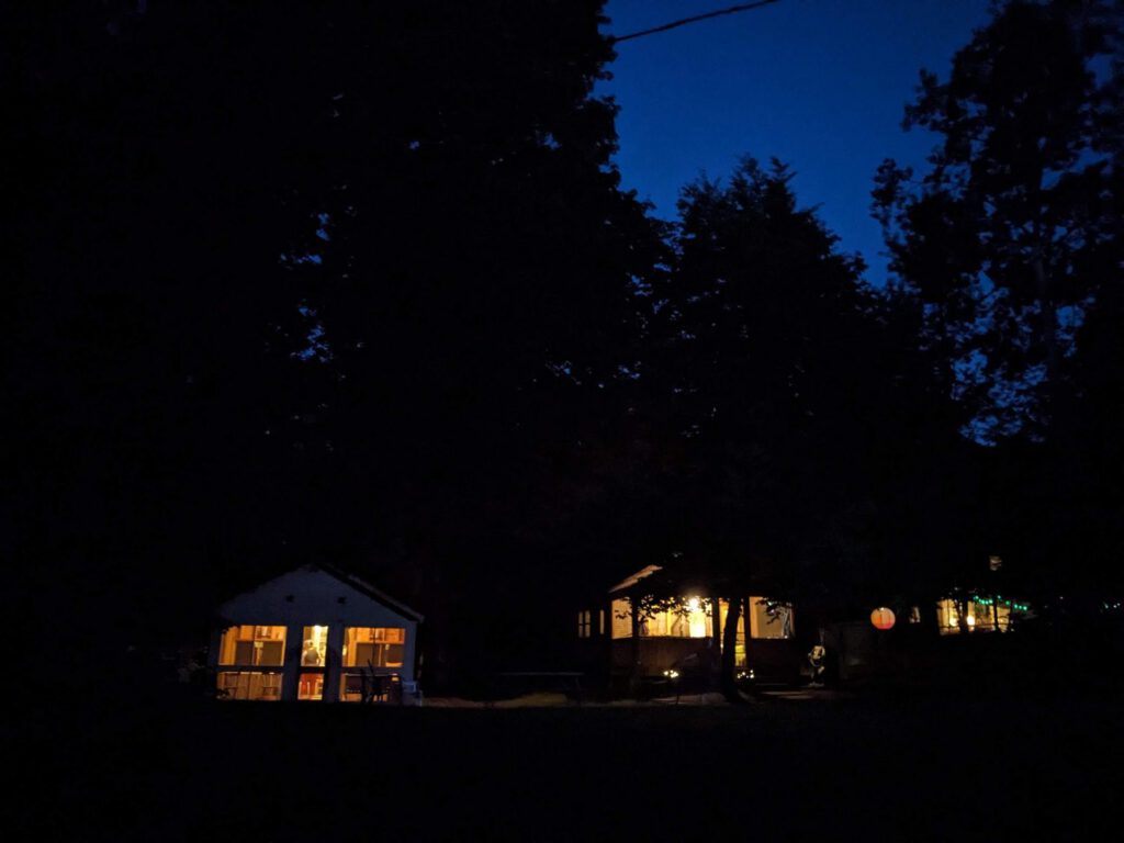 Cabins glow at dusk on the hill
