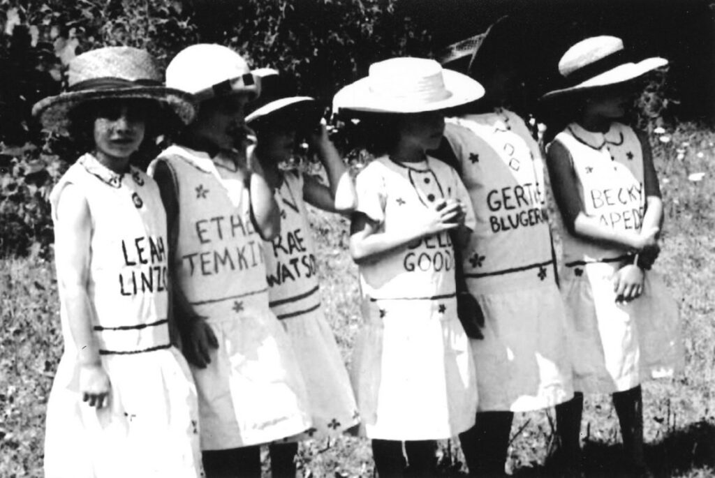 Naivelt children represent the six founding mothers (Leah Linzon, Ethel Temkin, Rae Watson, Bella Goodis, Gertie Blugerman and Becky Lapedes) during the Arum Dem Fayer pageant held at Camp in 1998
