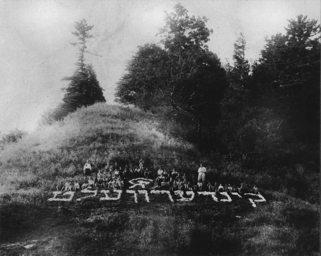 Campers spell out Yiddish lettering across the hillside at Camp