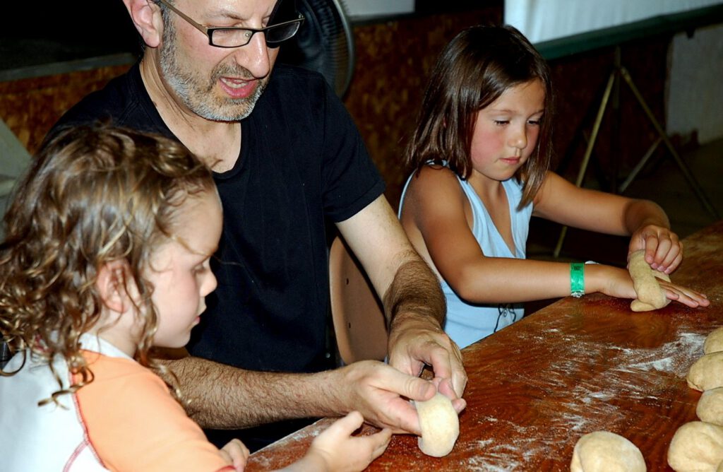 Alan Cantor leads children in a bagel-making workshop at the Lasowsky Centre