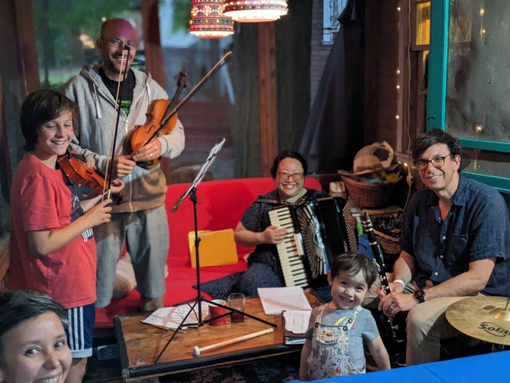A family music jam in a screened cabin
